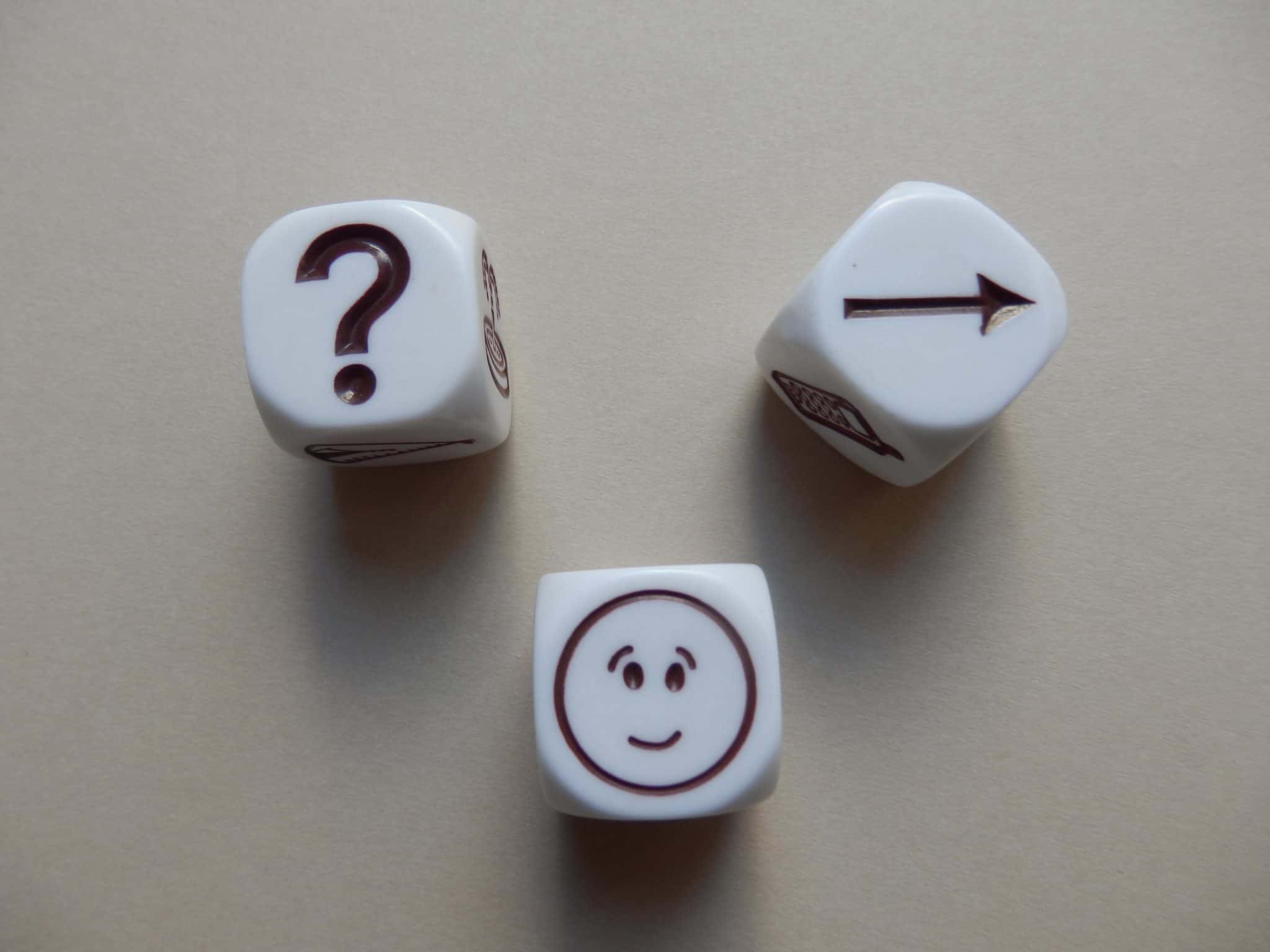 picture of dice showing a question, face and arrow towards the game of creating an online omnipresence.