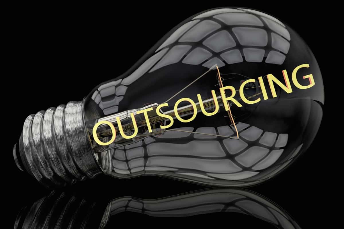 A lightbulb with the filament spelling Outsourcing for an outsourcing definition article