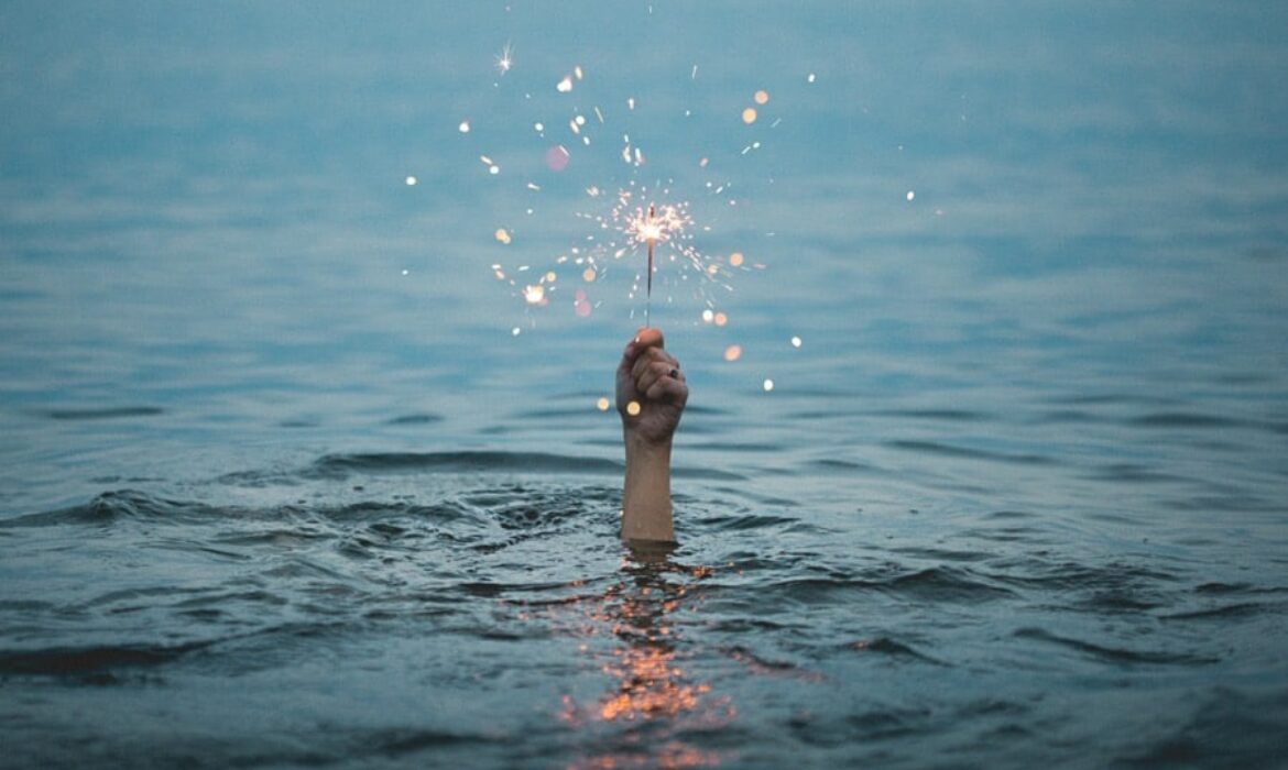 person under the sea holding a sparkler above water for and seo innovations article illustration