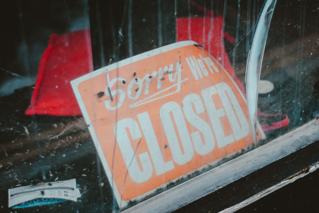 A closed sign in the window of a business which did not market itself properly in the recession